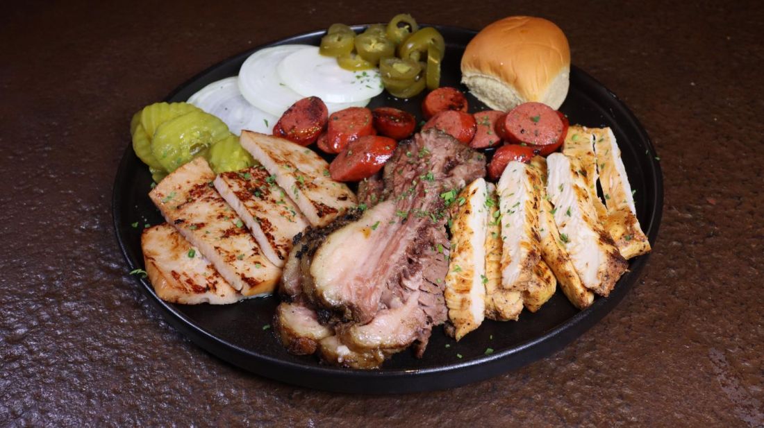 BBQ meat plate with brisket, sausage and grilled chicken