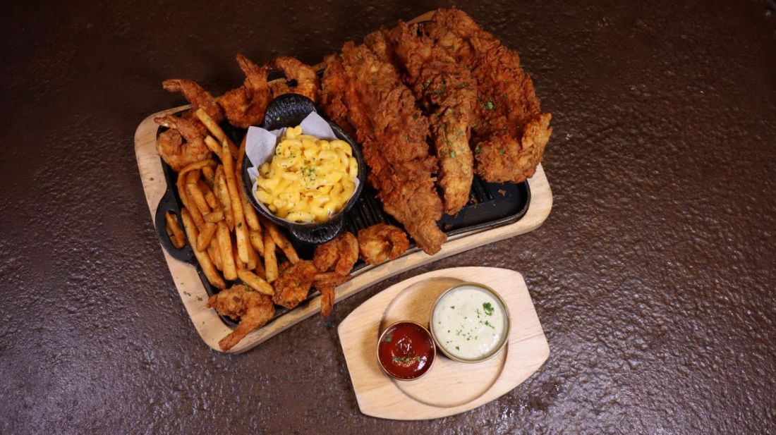 Fried chicken tenders with fries, sides and dipping sauces