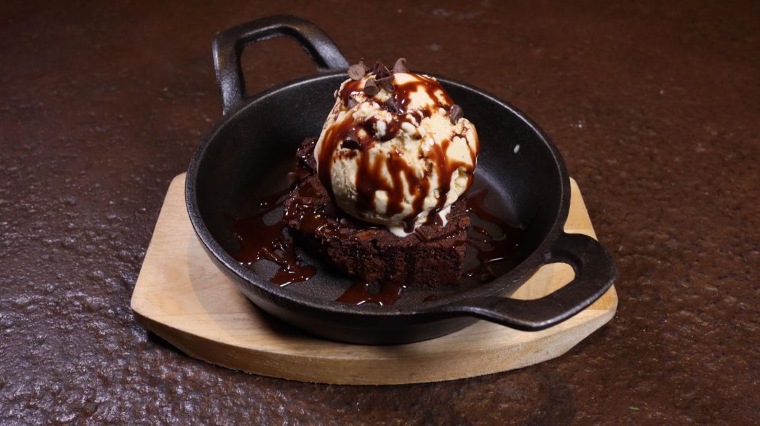 Brownie with ice cream in a cast-iron skillet