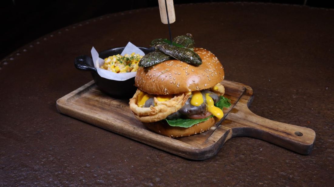 Loaded burger with a side of mac and cheese