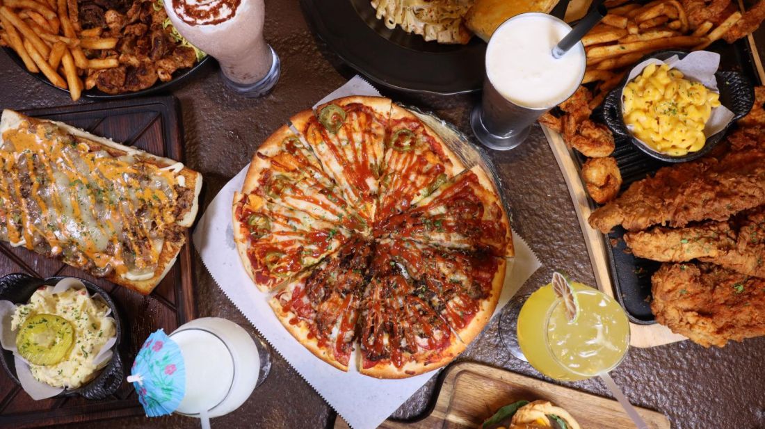 A spread of Mystic favorites: pizza, wings, fries and drinks